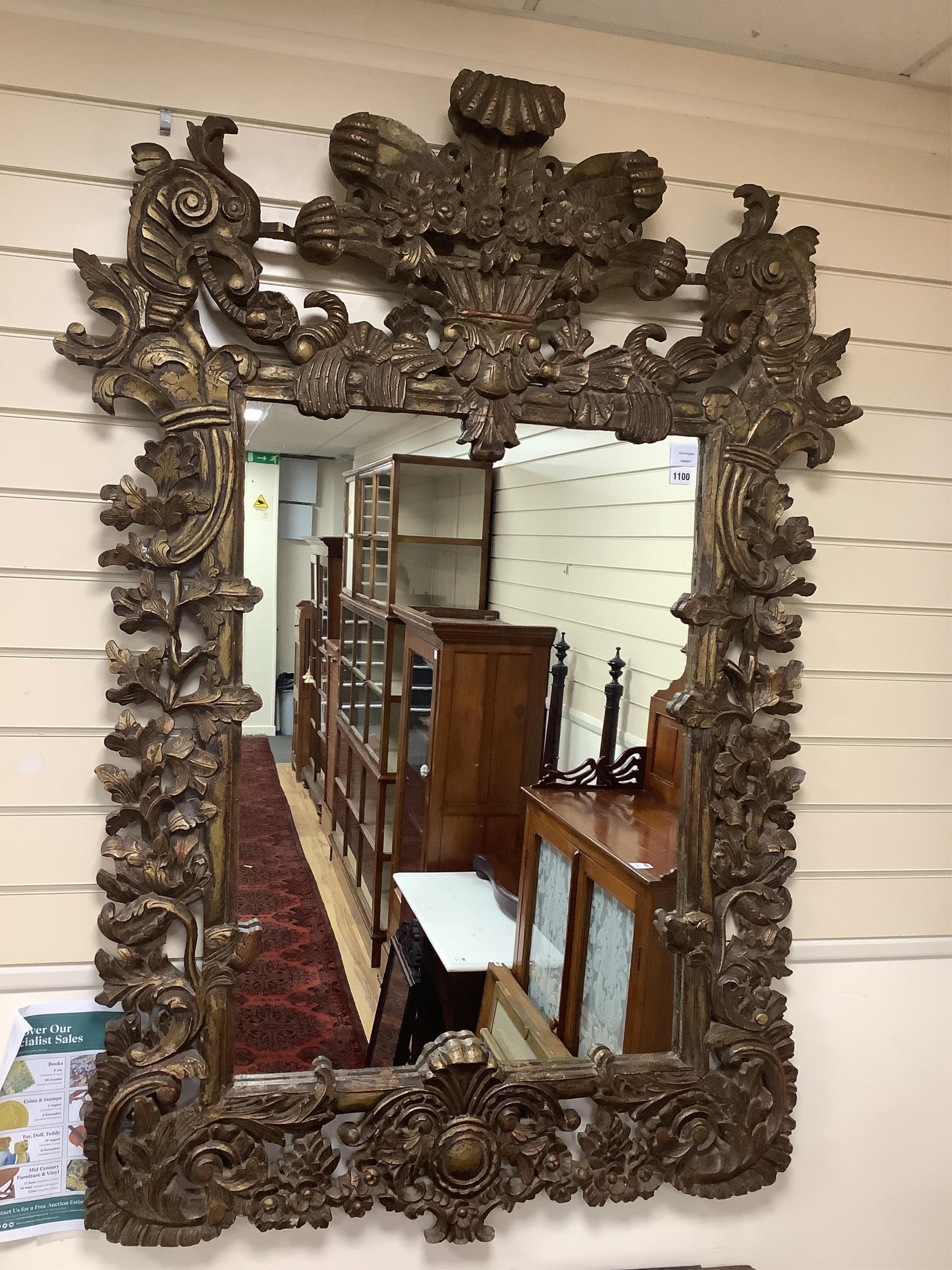 A late 19th century Anglo Indian elaborate carved and giltwood wall mirror, width 109cm, height 155cm. Condition - good